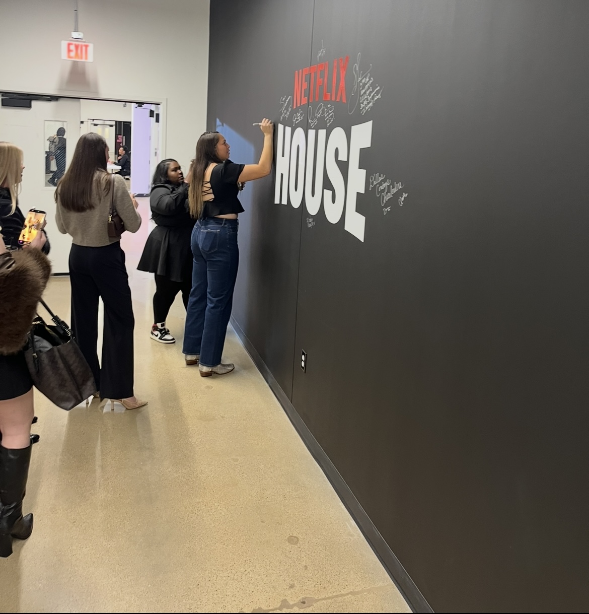 Dallas Trinity FC's Cam Lancaster Writing  Her Netflix Wall Signature - 1